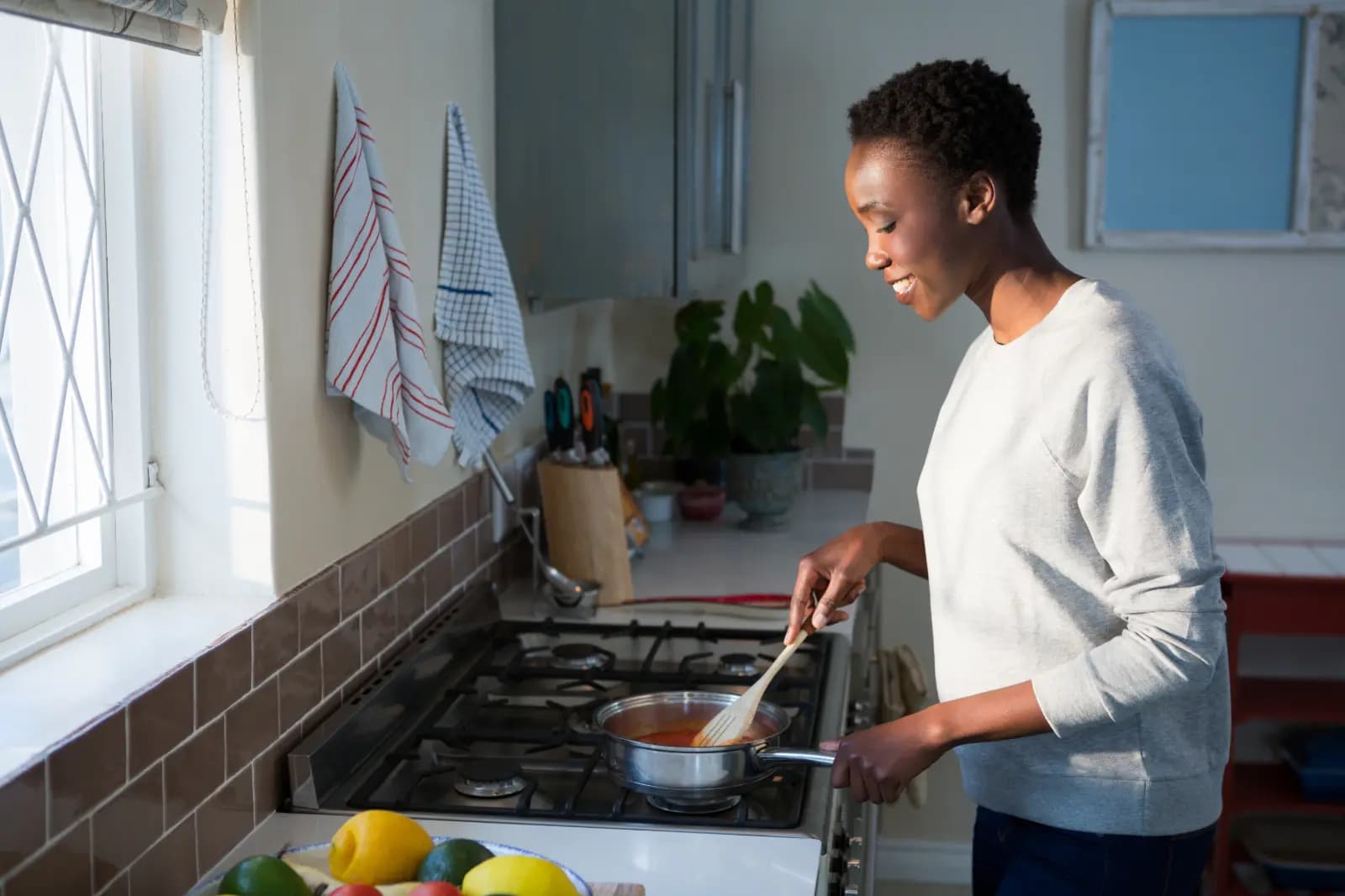 a woman cooking in a kitchen